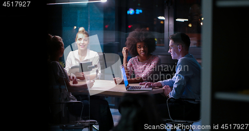 Image of Multiethnic startup business team in night office