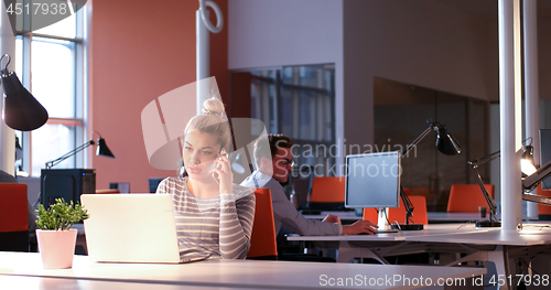 Image of businesswoman using a laptop in startup office