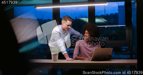 Image of Multiethnic startup business team in night office