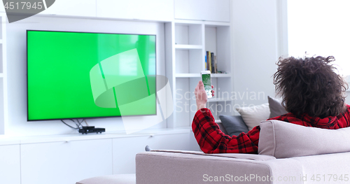 Image of Young couple on the sofa watching television