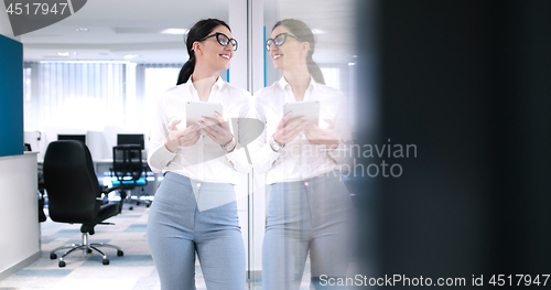 Image of Business Woman Using Digital Tablet in front of Office