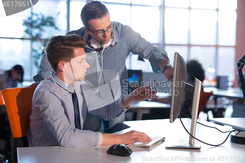 Image of Two Business People Working With computer in office