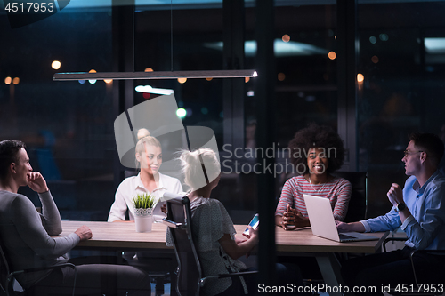 Image of Multiethnic startup business team in night office