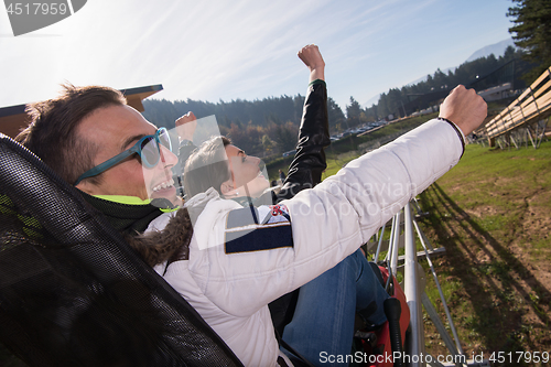 Image of couple enjoys driving on alpine coaster