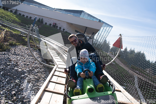 Image of father and son enjoys driving on alpine coaster