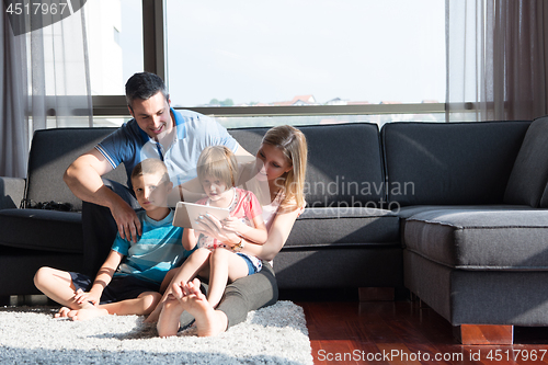 Image of happy young couple spending time with kids