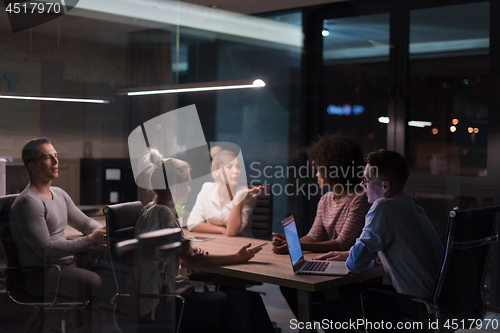 Image of Multiethnic startup business team in night office