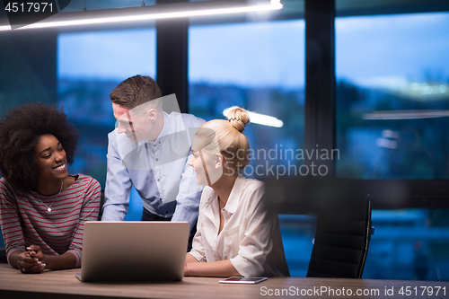 Image of Multiethnic startup business team in night office