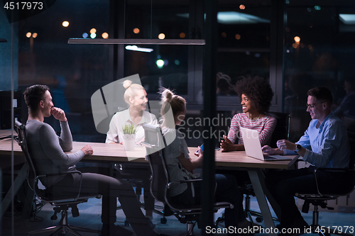 Image of Multiethnic startup business team in night office