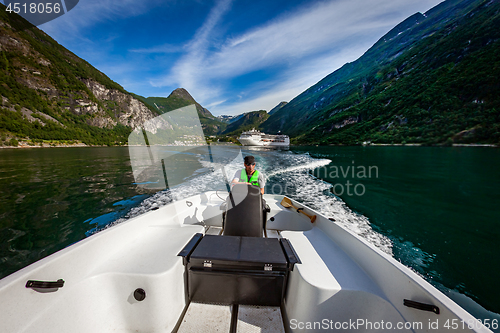 Image of Man driving a motor boat. Geiranger fjord, Beautiful Nature Norw