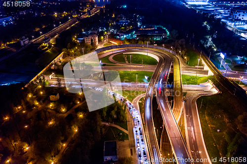 Image of Night Aerial view of a freeway intersection traffic trails in ni