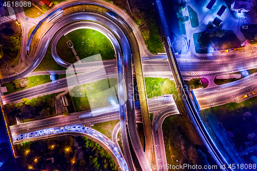 Image of Night Aerial view of a freeway intersection traffic trails in ni