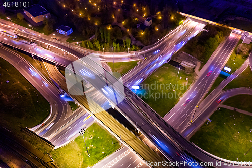 Image of Night Aerial view of a freeway intersection traffic trails in ni