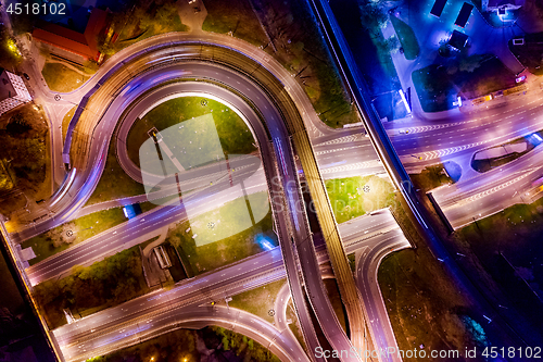 Image of Night Aerial view of a freeway intersection traffic trails in ni