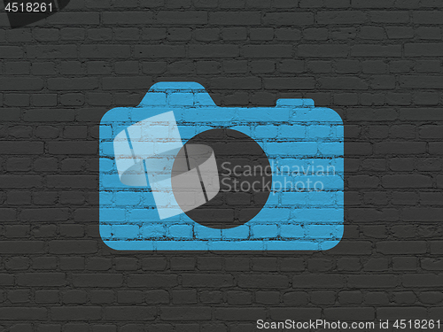 Image of Tourism concept: Photo Camera on wall background