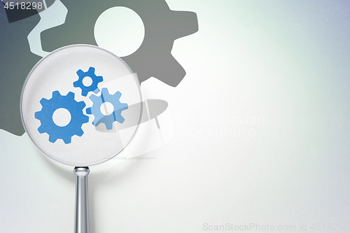 Image of Finance concept:  Gears with optical glass on digital background