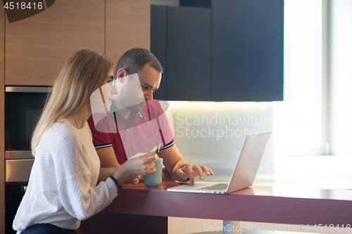 Image of happy young couple buying online