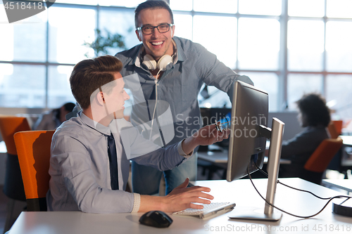 Image of Two Business People Working With computer in office