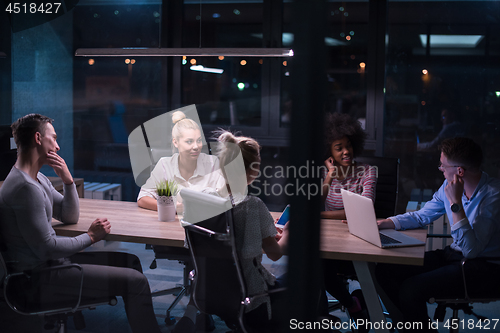 Image of Multiethnic startup business team in night office