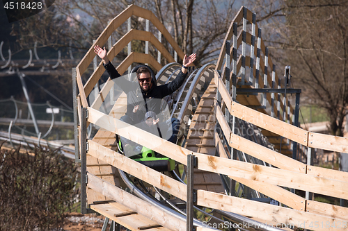 Image of father and son enjoys driving on alpine coaster
