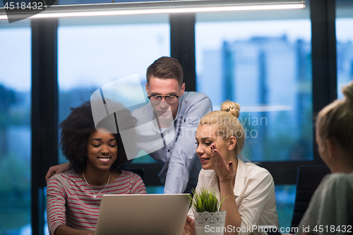 Image of Multiethnic startup business team in night office