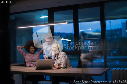 Image of Multiethnic startup business team in night office