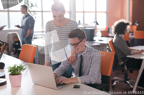 Image of Two Business People Working With laptop in office