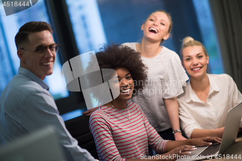 Image of Multiethnic startup business team in night office