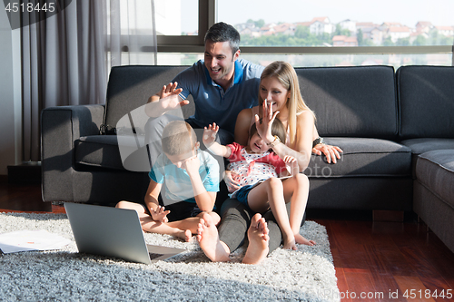 Image of Family Playing Together with laptop computer