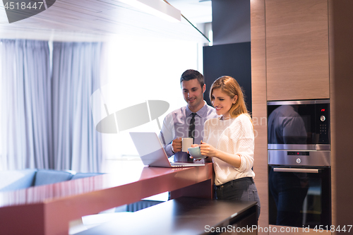 Image of A young couple is preparing for a job and using a laptop