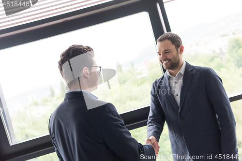 Image of cloasing the deal in modern office interior