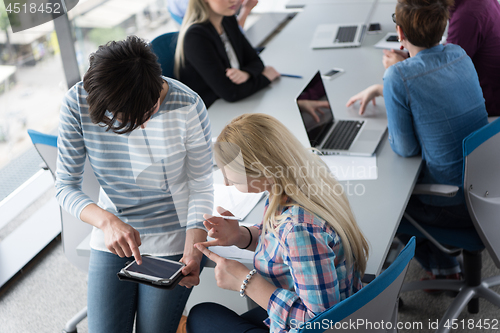 Image of Pretty Businesswomen Using Tablet In Office Building during conf