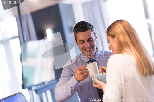 Image of A young couple is preparing for a job and using a laptop