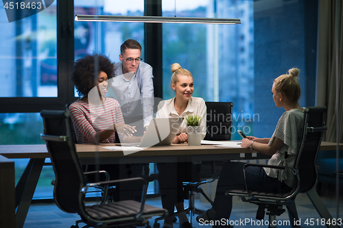 Image of Multiethnic startup business team in night office