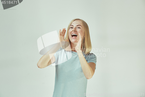 Image of Isolated on pink young casual woman shouting at studio