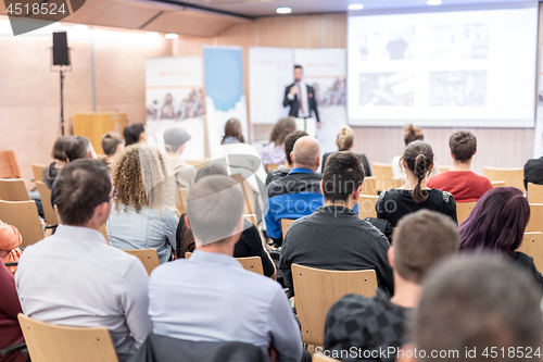 Image of Business speaker giving a talk at business conference event.