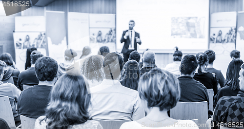 Image of Business speaker giving a talk at business conference event.