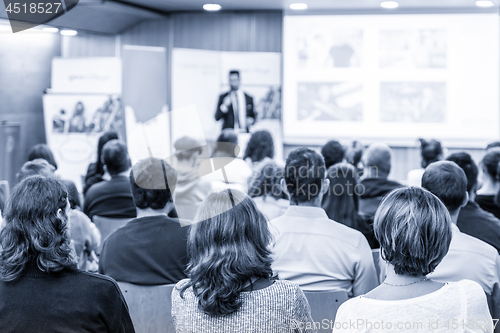 Image of Business speaker giving a talk at business conference event.