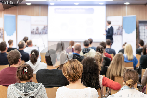 Image of Business speaker giving a talk in conference hall.