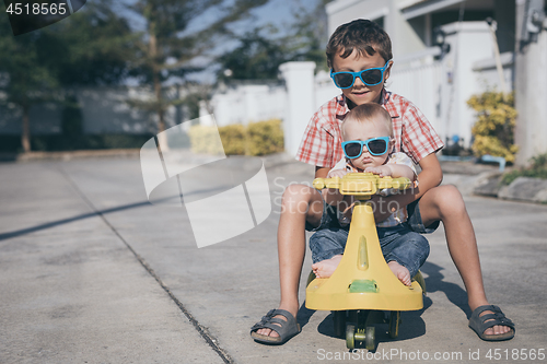 Image of Two happy little children playing on the road at the day time.