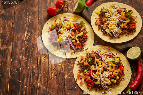Image of Healthy corn tortillas with grilled beef, fresh hot peppers, cheese, tomatoes