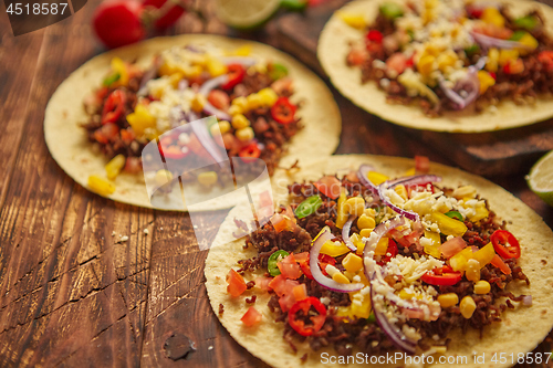 Image of Healthy corn tortillas with grilled beef, fresh hot peppers, cheese, tomatoes