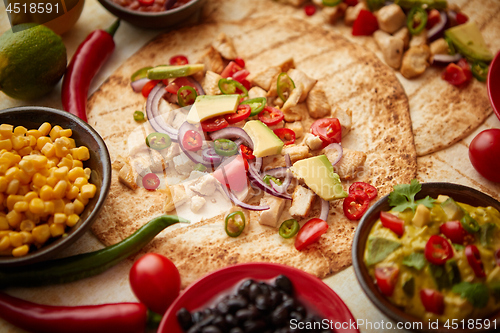 Image of Freshly made healthy corn tortillas with grilled chicken fillet, big avocado slices