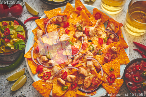 Image of Mexican corn nacho spicy chips served with melted cheese