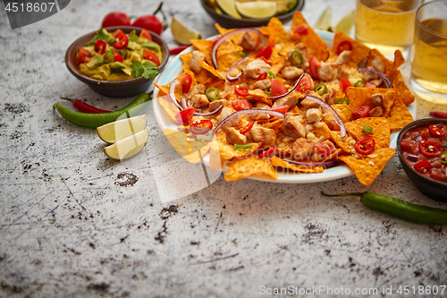 Image of Mexican corn nacho spicy chips served with melted cheese