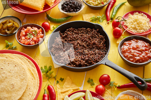 Image of Various fresh and tasty ingredients for chilli con carne. With meat on iron pan