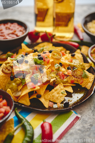 Image of Mexican corn nacho spicy chips served with melted cheese