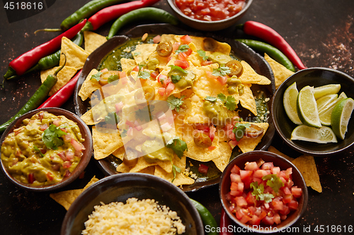 Image of Fresh yellow corn nacho chips on ceramic plate