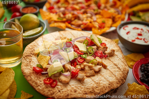 Image of An overhead photo of an assortment of many different Mexican foods on a table