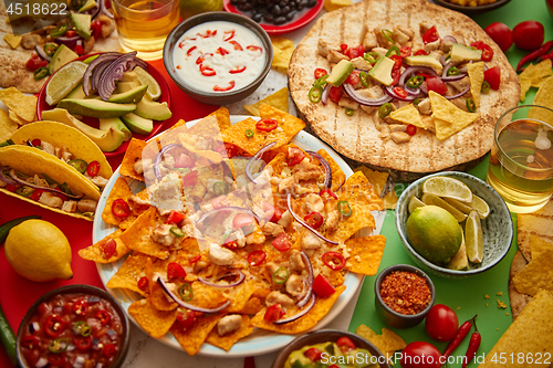 Image of Various freshly made Mexican foods assortment. Placed on colorful table